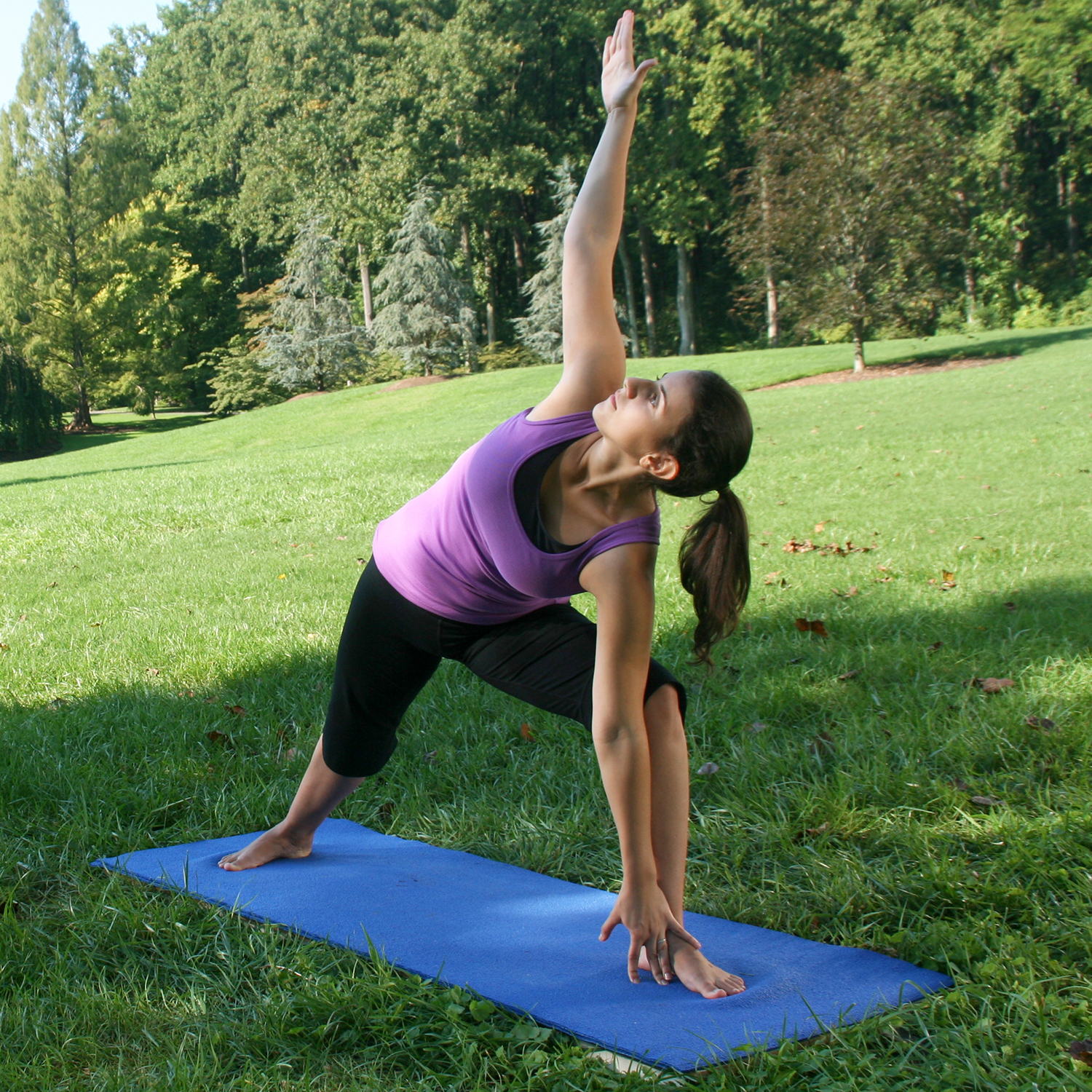 Woman practicing yoga in a park