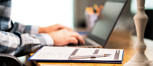 Woman at a computer filing for unemployment insurance