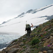 A scientist hikes up to a glacier in Glacier National Park.