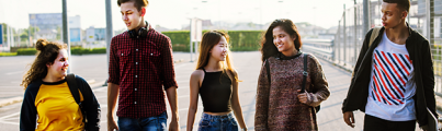 Five young people walking together