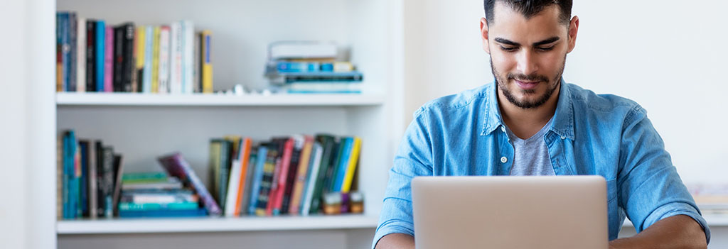 A man looking at a laptop computer.