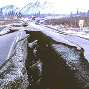 Image shows a road split due to earthquake damage