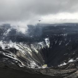 Unoccupied Aircraft System flying over volcano crater