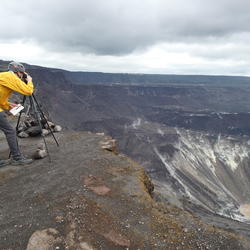 A scientists observes a volcano crater