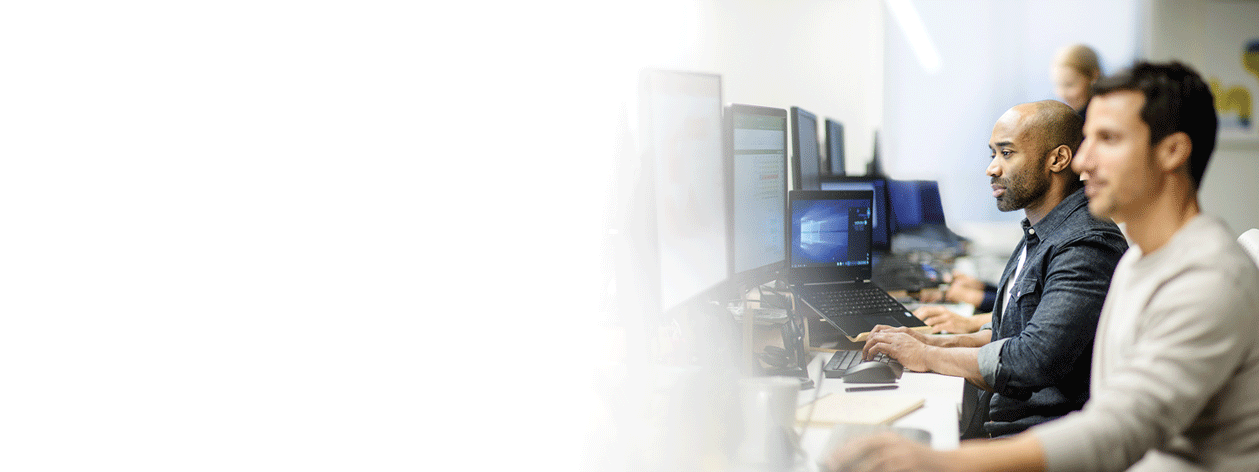 Two men working on computers together