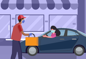 Restaurant worker handing food to a woman who is in her car at curbside delivery. 