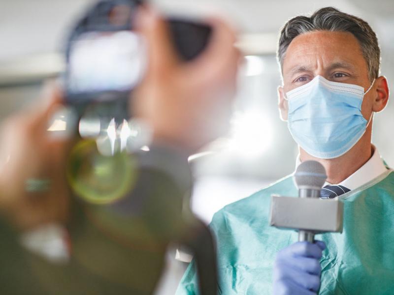 Physician giving an interview in front of the camera in the hospital