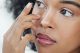 Woman putting contact lenses in her eyes