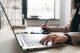 Woman keyboarding on laptop