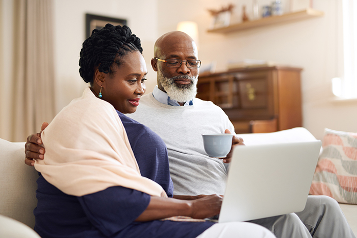 Photo of a man and a woman looking at a laptop computer