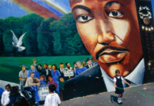 Children playing next to mural depicting Martin Luther King Jr. (© David Butow/Corbis/Getty Images)